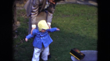 1951: mom helping baby walk in yard CLEVELAND, OHIO