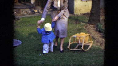 1951: baby taking his first steps with his mom holding him CLEVELAND, OHIO