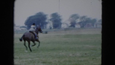 1951: a person riding a horse on an obstacle course