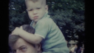 1962: father is walking with his son in top of his shoulder CATSKILL, NEW YORK
