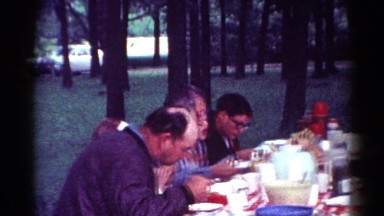 1964: people seated outdoor at a table enjoying a picnic CALIFORNIA