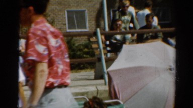 1964: people walking sitting on benches some in bathing suits beach umbrella