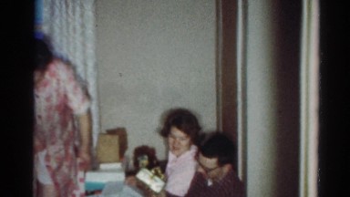 1964: three members of a family get together to wrap gifts CALIFORNIA