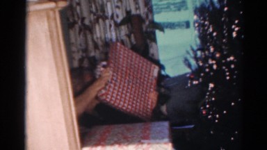 1964: an elderly woman opens a present on christmas day. CALIFORNIA