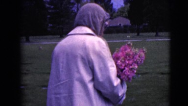 1968: woman walking dressed bread carrying road street flowers CLARKSDALE