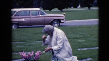 1968: pious and loving woman grieving at the grave of a loved one CLARKSDALE