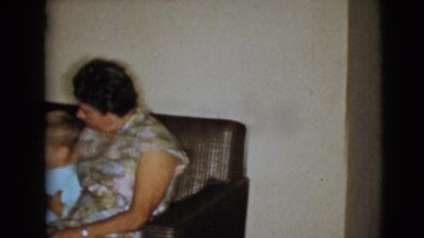 1968: grandparents sitting on couch with two young boys and dog CLARKSDALE