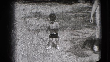 1942: Shirtless Toddler Explores Outdoors Holding Cup in New York