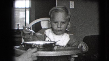 1942: kid eating indoor food toddler sitting NEW YORK