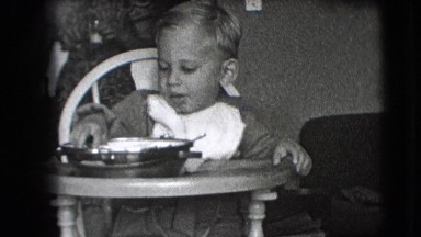 1942: small kid is trying to eat his food NEW YORK