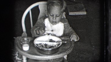 1942: a mother feeding a little boy seated in a high chair NEW YORK