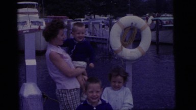 1965: a mother with three excited children eagerly anticipating a boat ride