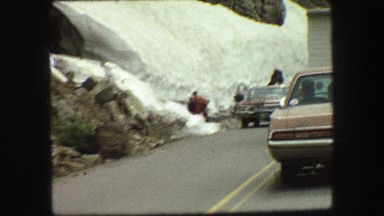 1967: people walking and driving along a rugged ice-covered mountain