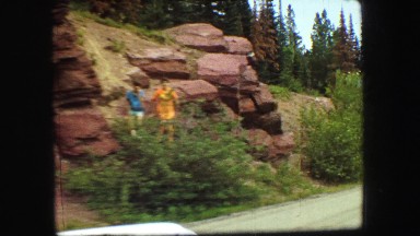 1967: people standing on the edge of a large rugged mountain
