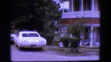 1968: different types of car being parked near a villa. DILLER, NEBRASKA