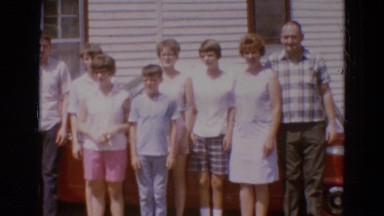 1968: a large family standing in front of their home in a row DILLER, NEBRASKA