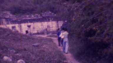 1973: group of people walking towards a compound in a forest MEXICO