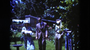 1951: family is carrying a newborn baby on the street CLEVELAND, OHIO