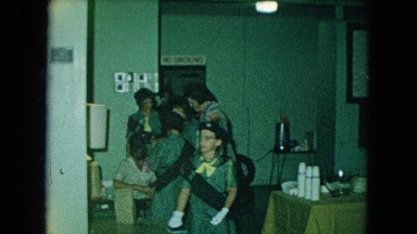 1966: Parents and Girl Scouts Gathered Indoors California