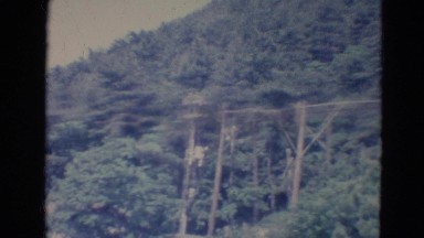 1976: A Panoramic View of a Chalet on a Mountain Side with Other Houses Nearby