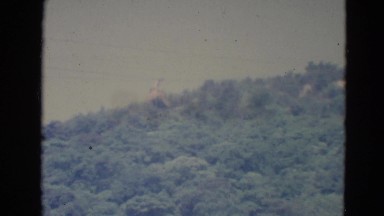 1976: a chairlift approaching a wooded mountain MINNESOTA