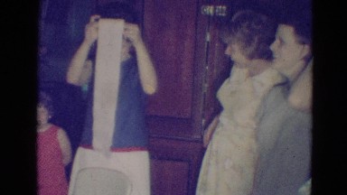 1976: A Woman Rolling Toilet Paper While Children and Women Watch