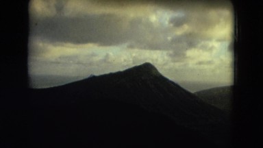 1966: the view of a cloudy sky with sunlight above mountains HAWAII