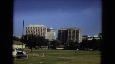 1967: large buildings bordering a large green area on a clear day HAWAII