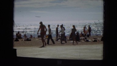 1967: tourists moving about on a beautiful ocean beach HAWAII