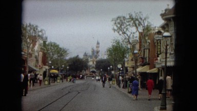 1967: a theme park with a castle and people exploring DISNEYLAND, CALIFORNIA