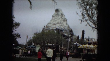 1967: people walk by rides in an amusement park. DISNEYLAND, CALIFORNIA