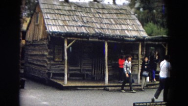 1967: tourists walking out of a log cabin DISNEYLAND, CALIFORNIA