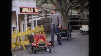 1967: a man with his dog observing a little town DISNEYLAND, CALIFORNIA