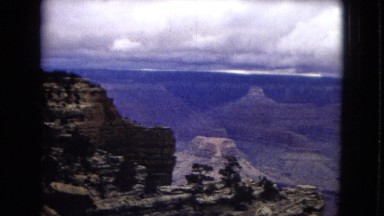 1967: a beautiful view of a massive canyon under a cloudy sky ARIZONA