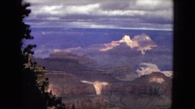 1967: a breathtaking large canyon as seen through a grove of trees ARIZONA