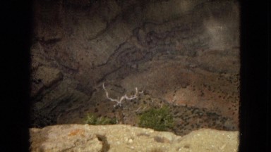1967: view of a rocky canyon showing layers of sediment and colorful formations
