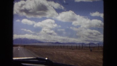 1967: view from a moving vehicle along a lonely desert road