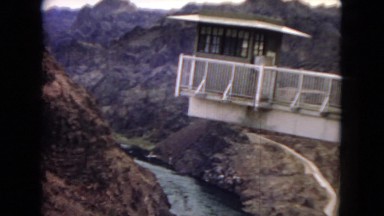 1967: a small building overhangs on a cliff edge over a river