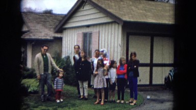 1967: an ethnic family is gathered in front of house CALIFORNIA