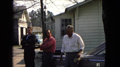 1967: three handsome young men and an old man are standing near to a car ARIZONA