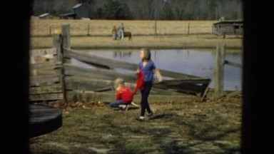 1967: Two Girls Running by Wooden Fence and Pond Arizona