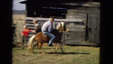 1967: a young adult riding a pony difficulty in a rural area ARIZONA