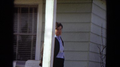 1967: man in dark suit standing on house porch ARIZONA