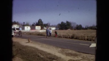 1967: a group of people are walking down a country road accompanied by a boy