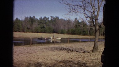 1967: two people in black row boat are next to two people in white rowboat