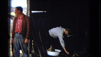 1967: several men are standing in the doorway of a barn talking and smiling