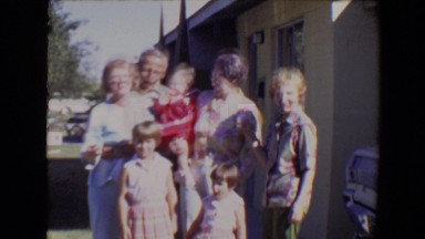 1967: multiple generations posing in a bright sunny driveway TUCSON, ARIZONA