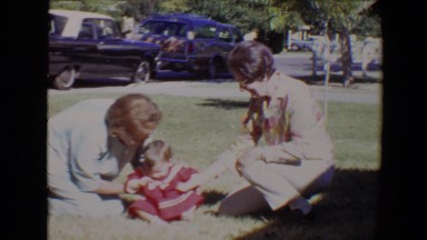1967: family coming together and posing in the sunny front yard TUCSON, ARIZONA