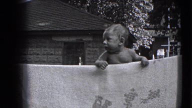 1941: A Confused Baby on a Clothesline in a New York Backyard