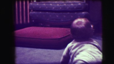 1942: a little baby crawling towards a chair. NEW YORK